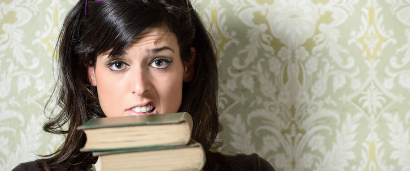 Girl holding a stack of books