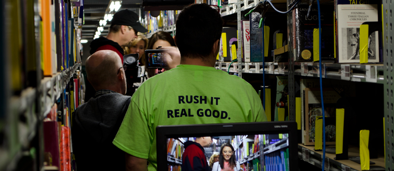 Behind the scenes photo of a video shoot in the TextbookRush warehouse