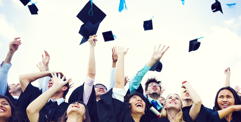 Graduates throwing their caps in the air