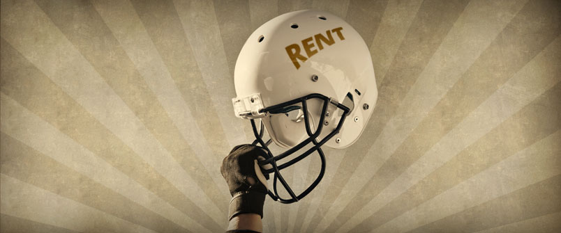 Person holding a football helmet with "Rent" on the side