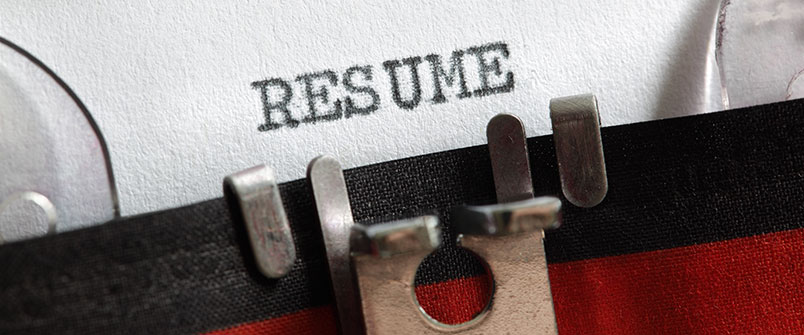 Paper in typewriter with the word "Resume" on it