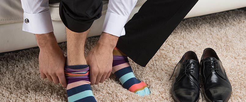 Guy putting on dress socks