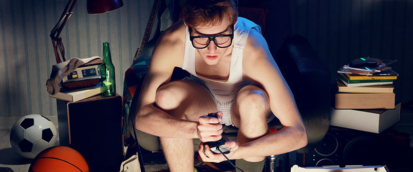 Guy playing video games at night