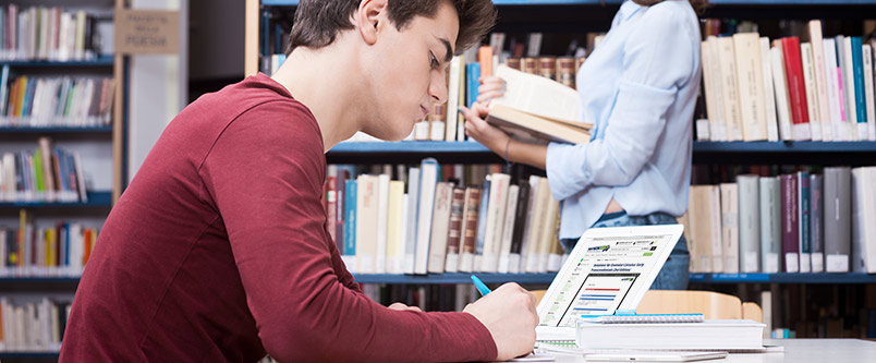 Student studying in front of a laptop