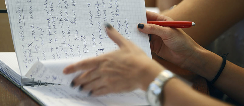 Student flipping through a notebook