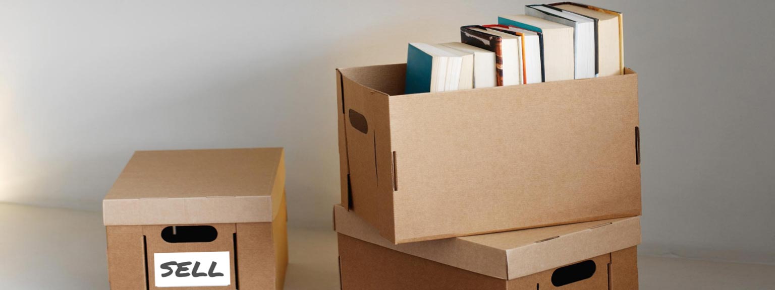Books in boxes labeled sell