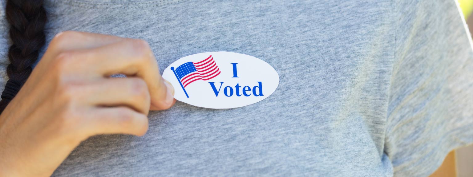 A person wearing an I Voted sticker