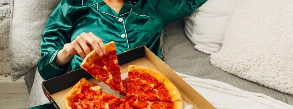 Someone relaxing and enjoying pizza