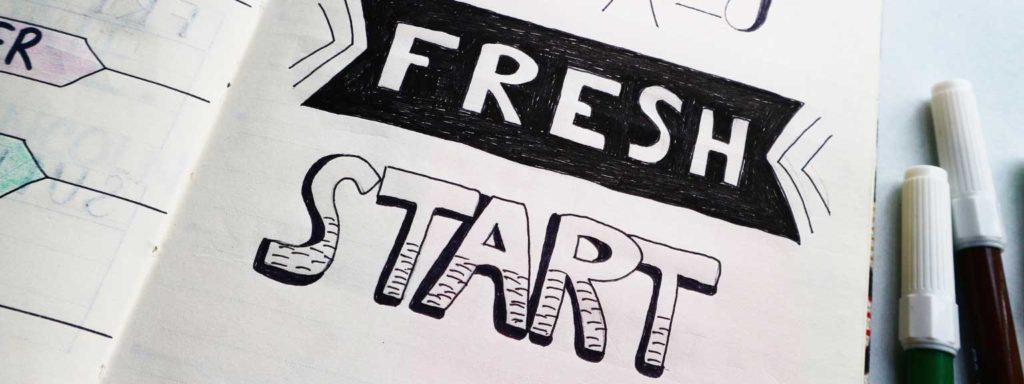 The words 'fresh start' drawn in a notebook