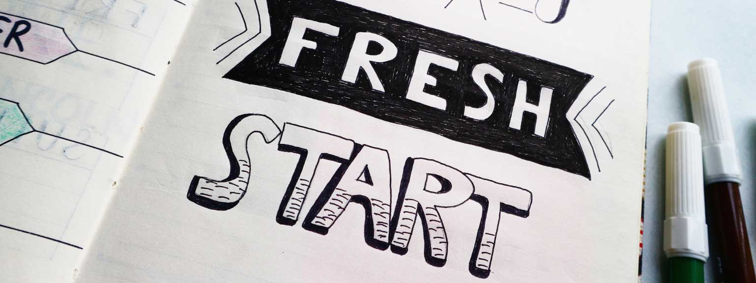 The words 'fresh start' drawn in a notebook